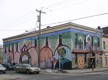 Large mural on two sides of an old two-story corner building