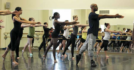 COCA alumnus Antonio Douthit, now with Alvin Ailey American Dance Theater, works with COCA student company members. Douthit returns to COCA annually to teach COCA students during a two-week residency. Photo courtesy of COCA