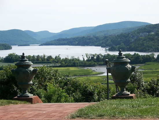 a sweeping country view of gardens backgrounded by the Hudson River and mountains