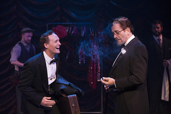 Two actors in tuxedos onstage