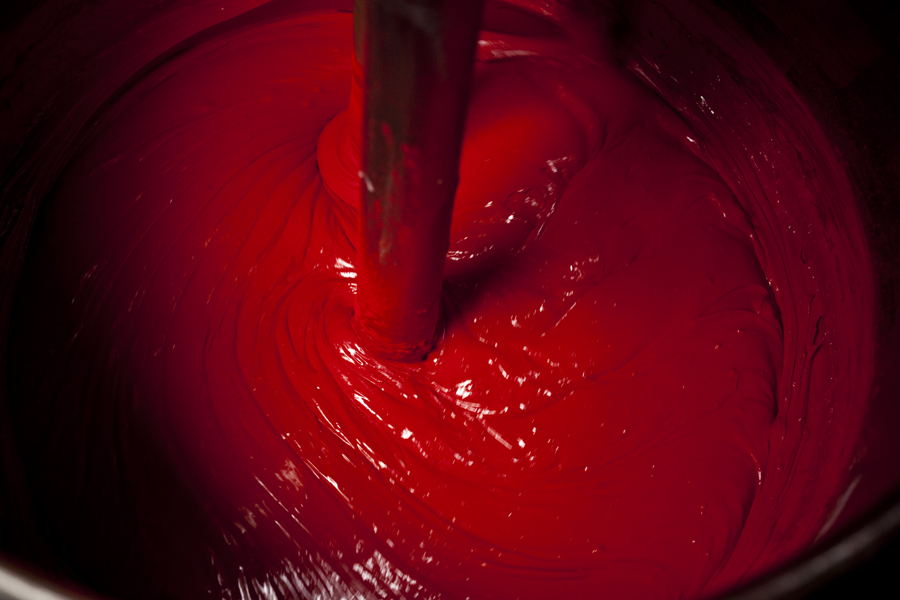 Red paint being mixed. 