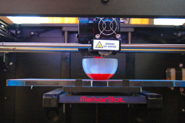 A 3D printer at work creating a bowl