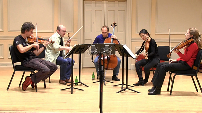 a string quintet practicing.