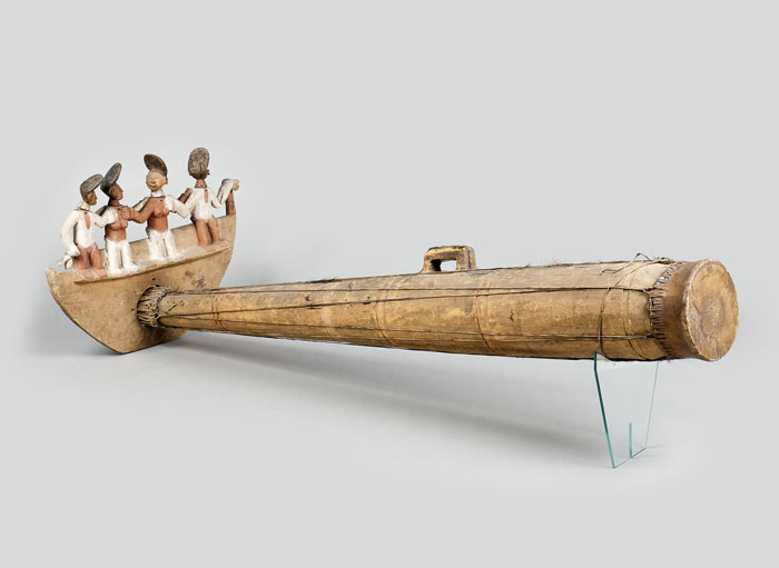 Long drum with figures of people on it