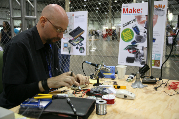 Man tinkering with robotic mice