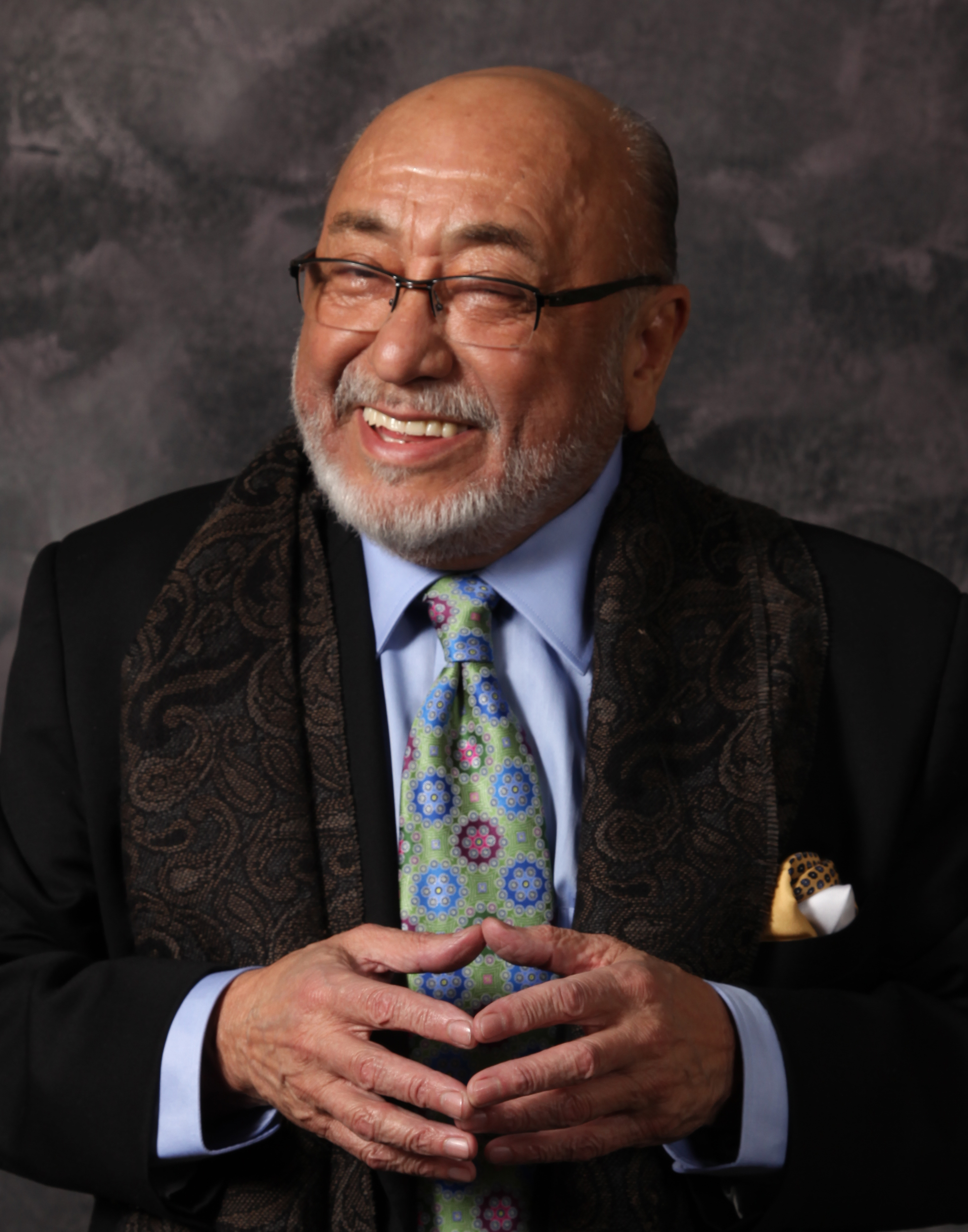 Eddie Palmieri Portrait Man smiling with hands close together