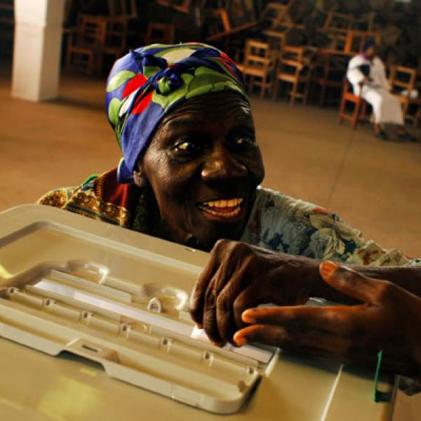 An excited Liberian woman casts her presidential ballot in 2005