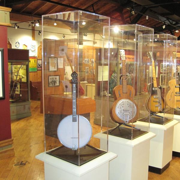 Instruments in glass cases inside a museum gallery. 