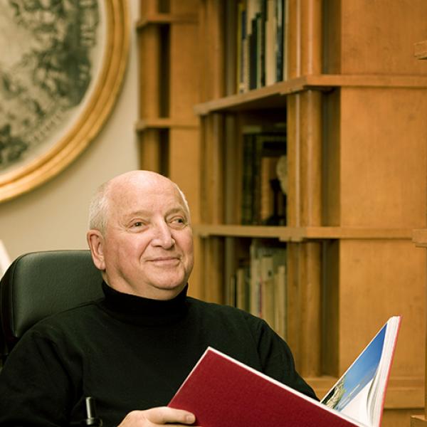 Michael Graves sitting with book in hands. 