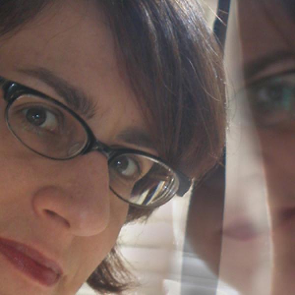 Woman wearing glasses and her reflection
