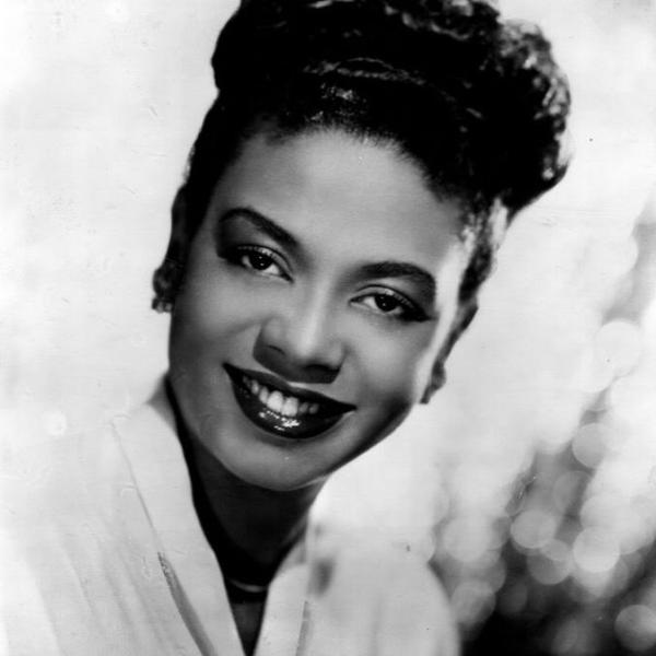 Black and white photo of a Black woman smiling