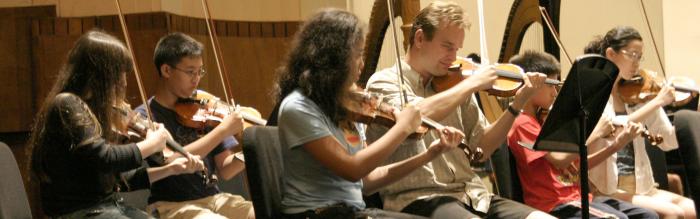 Students rehearsing a string piece