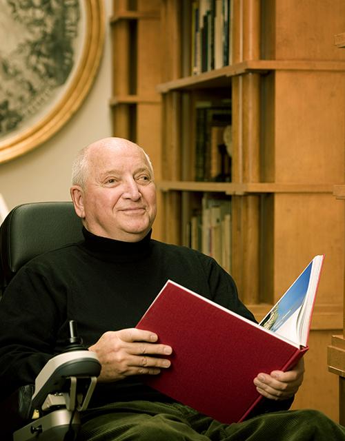 Michael Graves sitting with book in hands. 