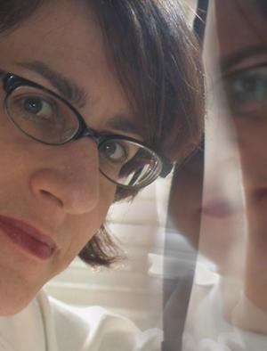 Woman wearing glasses and her reflection