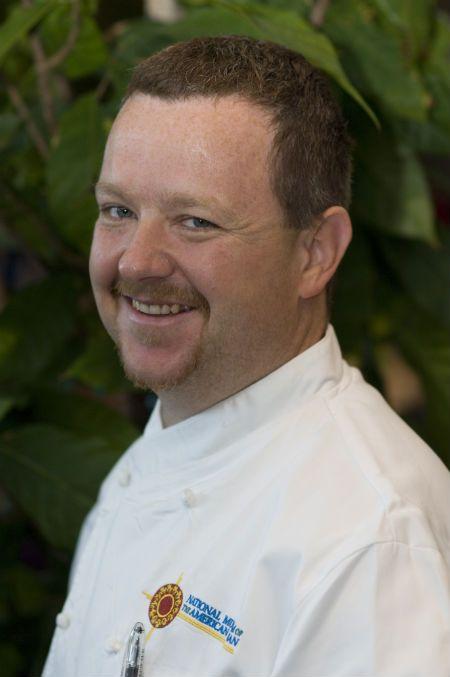 headshot of a white man in chef whites