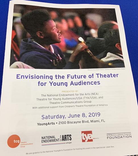 cover of paper program for convening with text and photo of a young man watching a performance