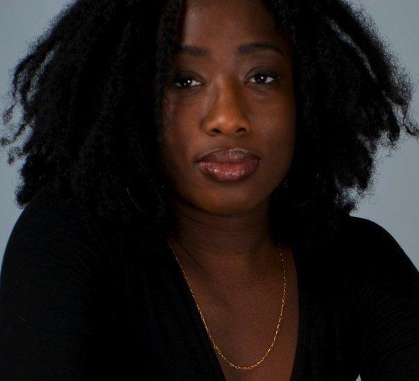 Photo of Black woman with a black shirt and gold necklace