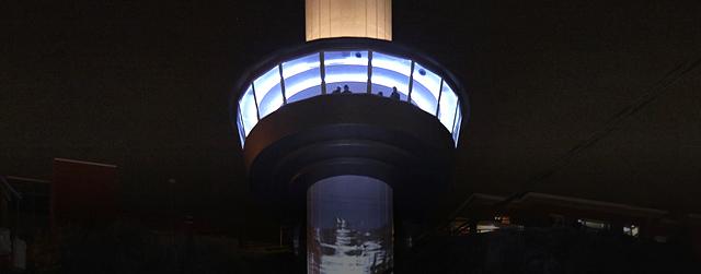 Outdoor elevator tower illuminated at night