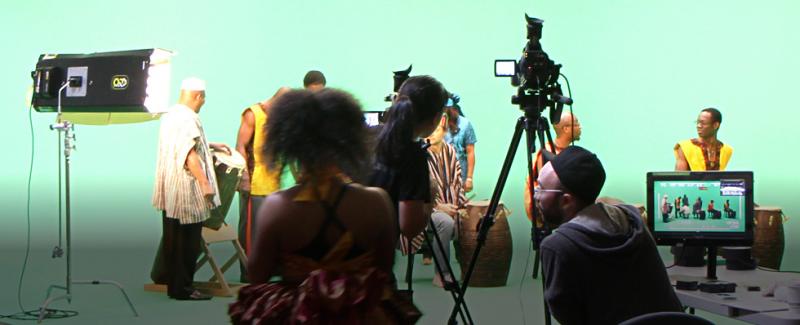 Music group setting up in front of a green screen getting ready for a broadcast