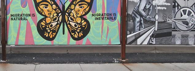 Detail from a large mural with a panel supporting immigration and another with a WPA representation of a worker