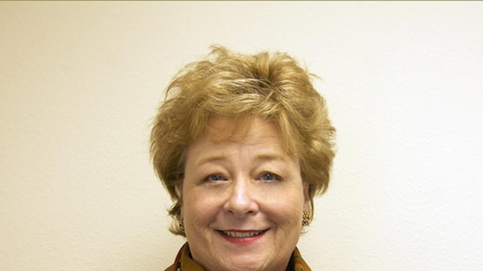 headshot of older white woman with short reddish hair
