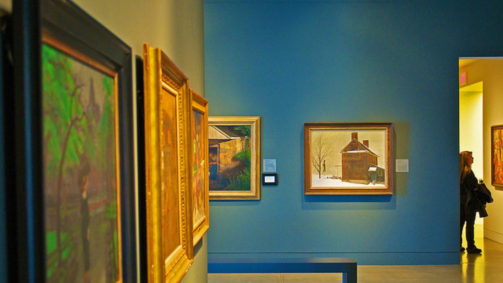 Museum hallway lined with paintings