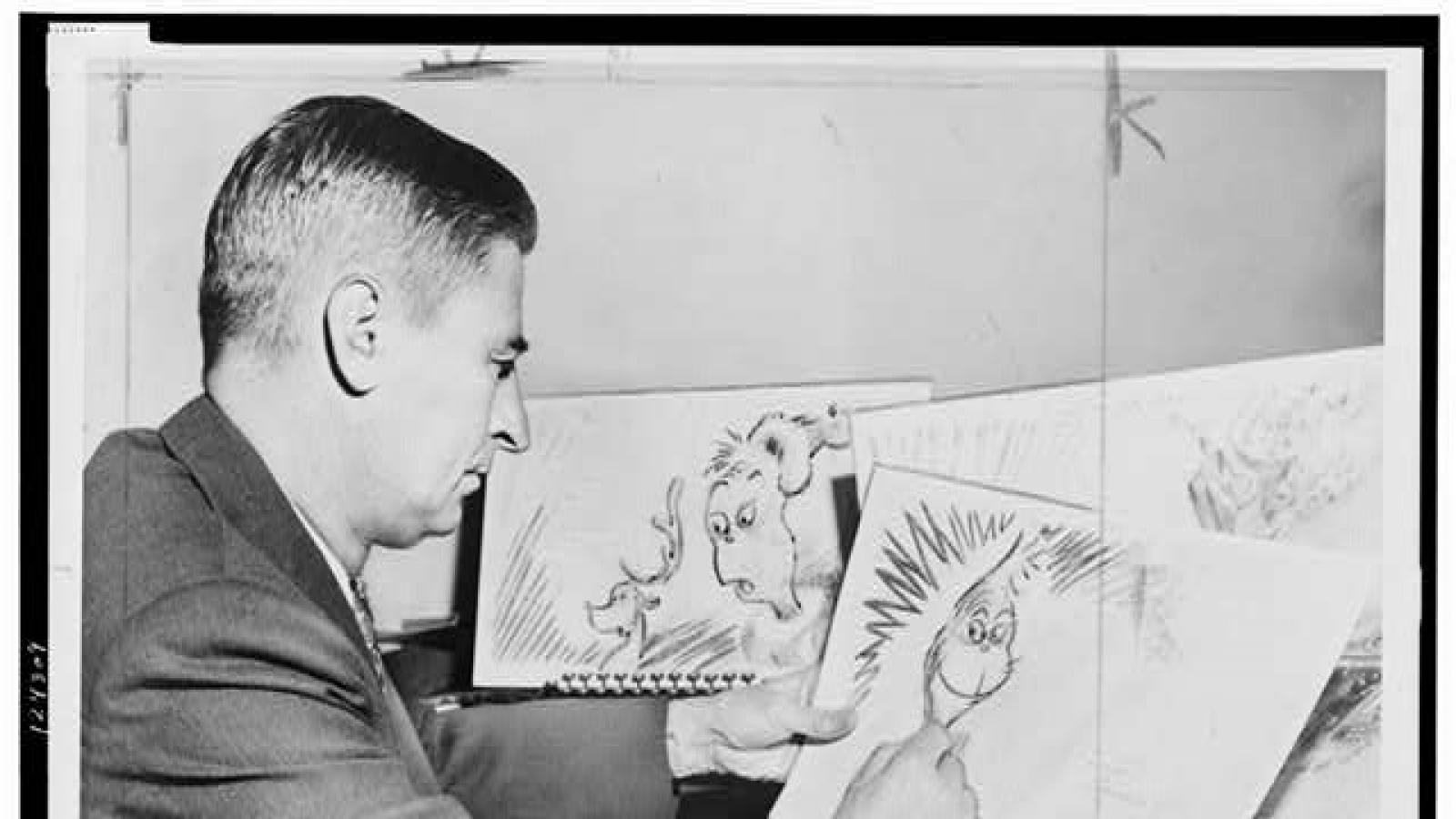 Dr. Seuss drawing an image of the grinch