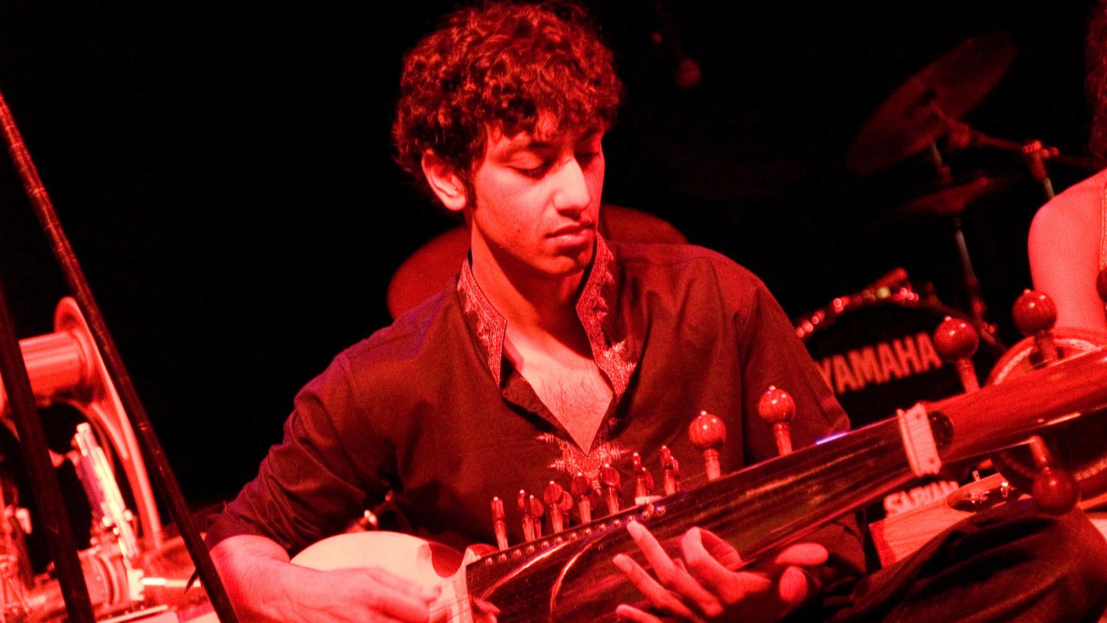 Man playing the stringed instrument, the sarod.