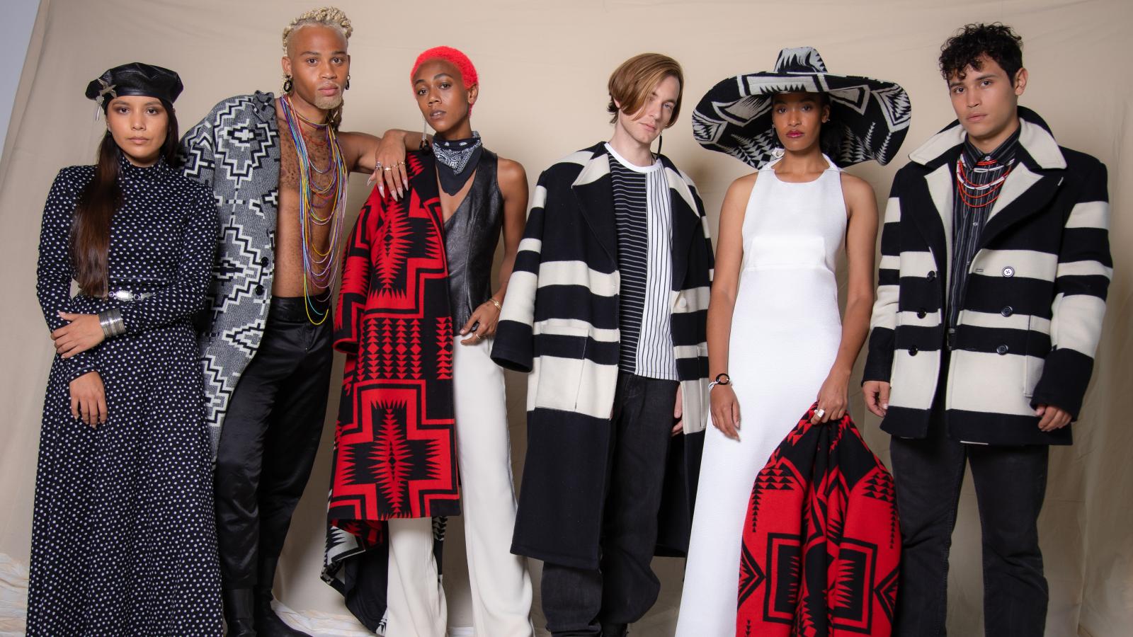 A group of male and female models posing with clothing with a Native American motif. 