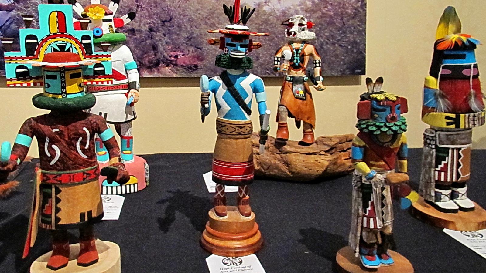 A display of colorful carved katsina dolls made by Hopi artists