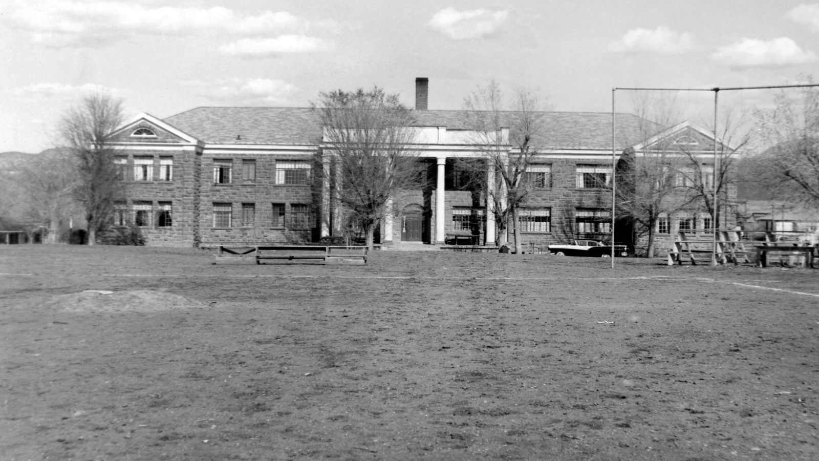 Black and white photo of a large building used as a boarding school. 