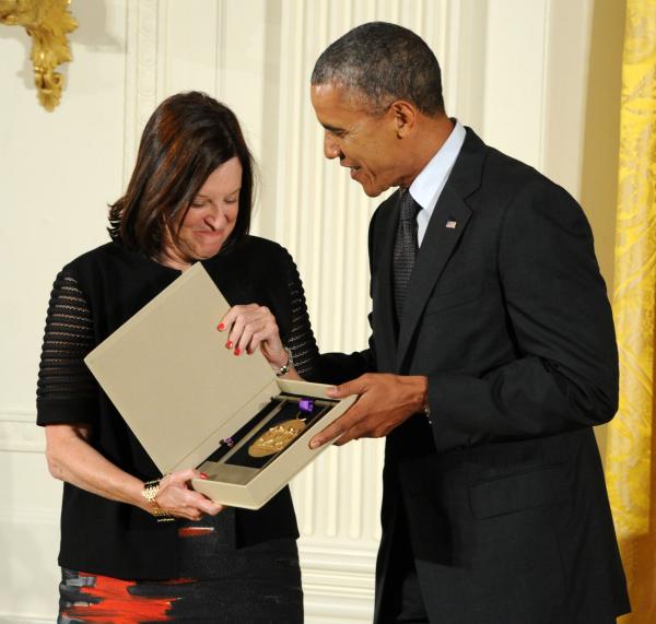 Karen Hopkins receiving an award from Barack Obama