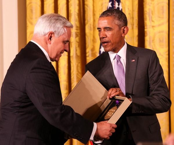 Kenneth Fisher receives the medal from President Obama