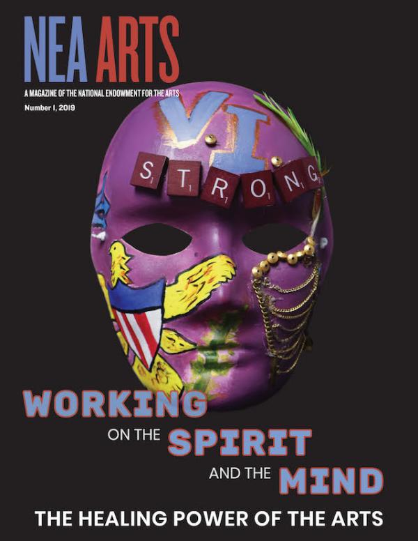 Cover of NEA Arts magazine with a mask on it with the word strong and other embellishment