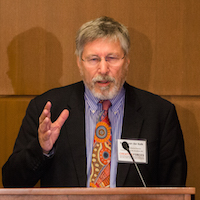  A man stands behind a podium giving a speech. 