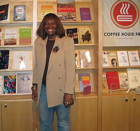 Patricia smith in front of a display case of books.