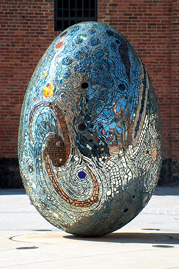 An egg shaped sculpture mosaiced with mirrored pieces