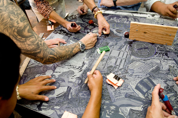 Prisoners carving linoleum block