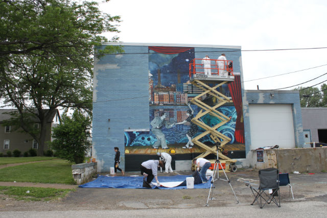 A mural being erected on the side of a building