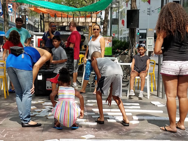 people writing poems on the sidewalk