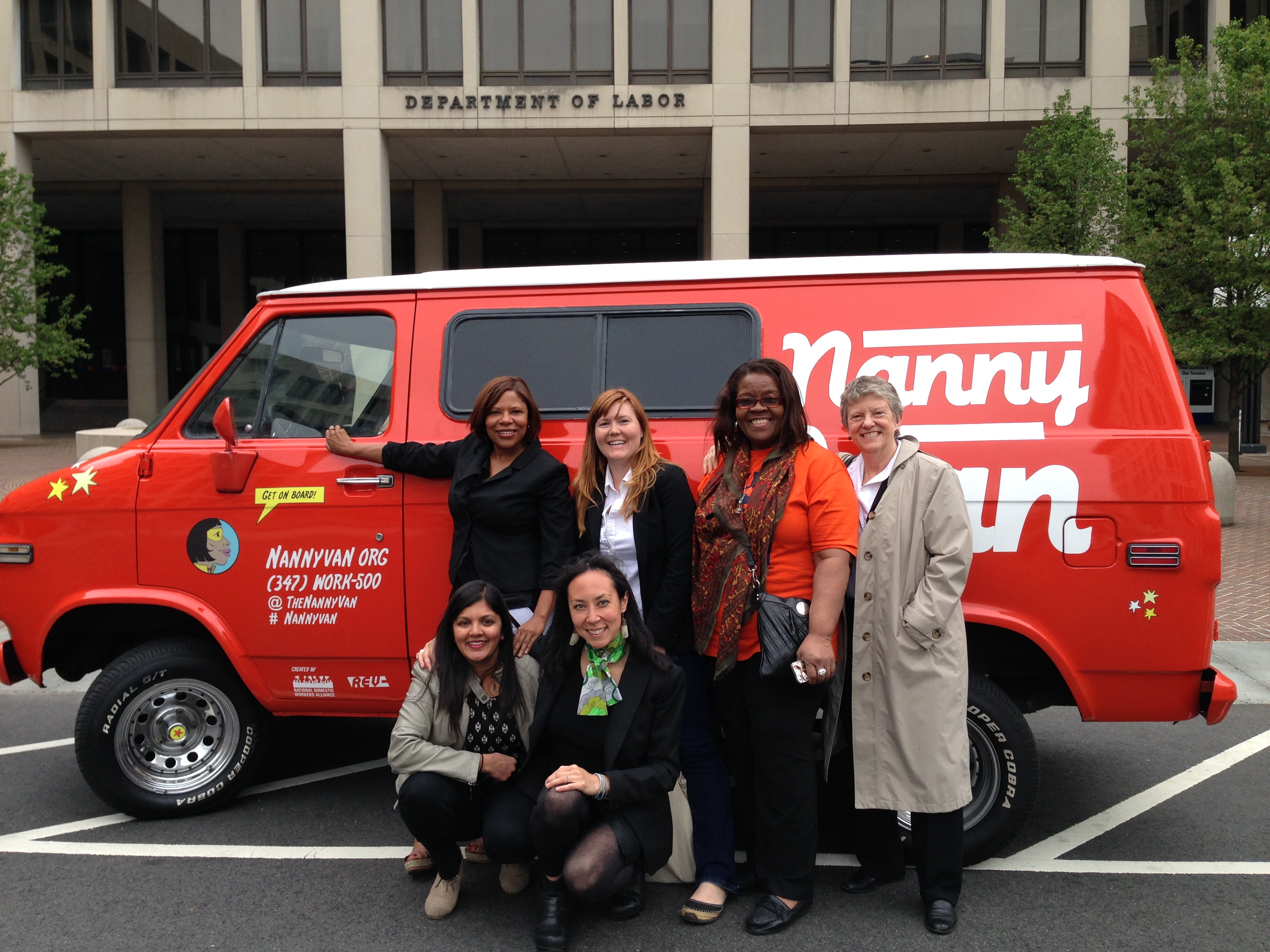 Women standing in front of a van. 