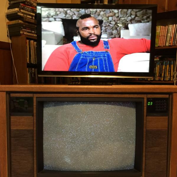 Flat-screen television resting on CRT television