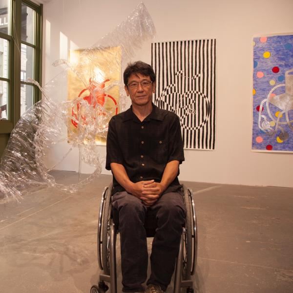 man in wheelchair in an art gallery.