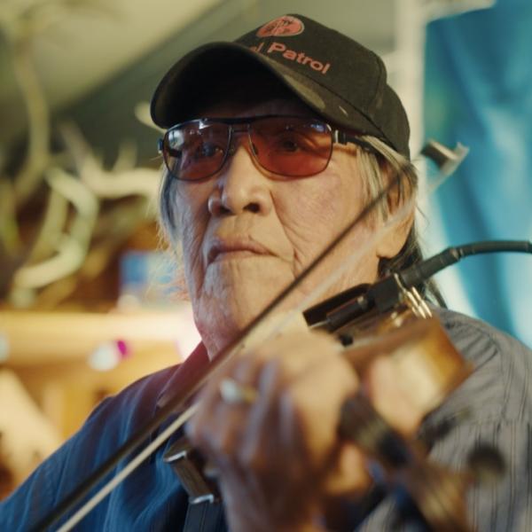 Close-up of Trimble Gilbert playing the fiddle