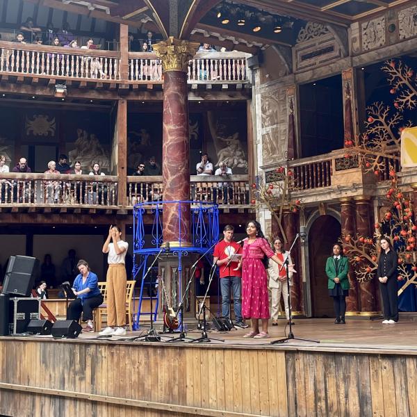 A young Indian woman recites on the Globe stage