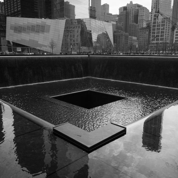 Black and white photo of the 9/11 memorial in New York City