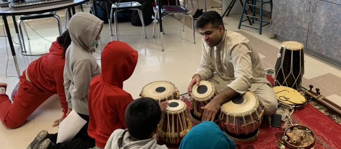 Devesh Chandra demonstrates drumming techniques to students