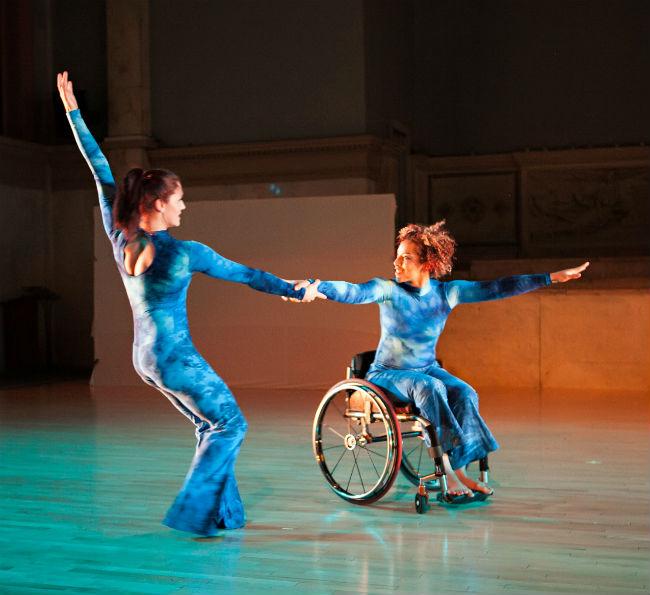 Two disabled dancers dancing with wheelchairs