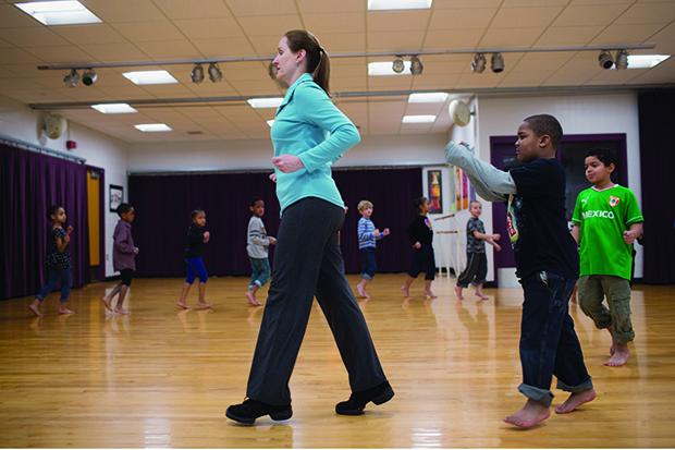 Woman teaching a dance class to young children