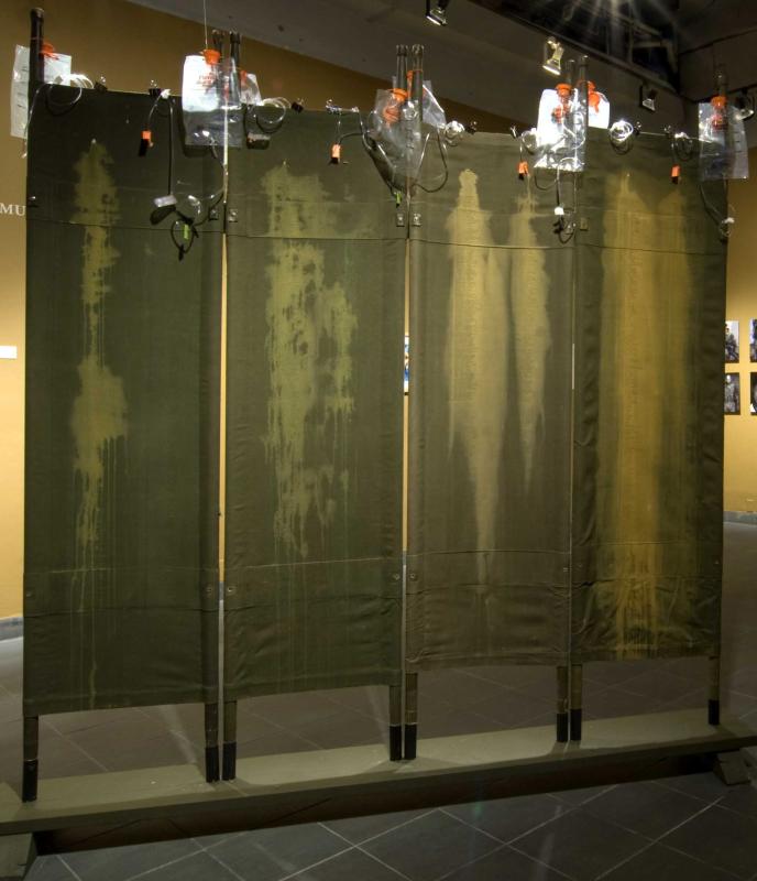 an artwork in which "blood stains" are silk screened on military stretchers